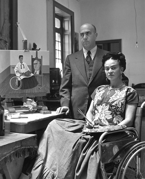 leuc:  Frida Kahlo, Self portrait with portrait of Dr. Farill, 1951.ph Gisèle FreundKahlo poses in a wheelchair, with palette and brushes, with the doctor who performed her seven spinal operations the year before. In the painting next to them, she uses