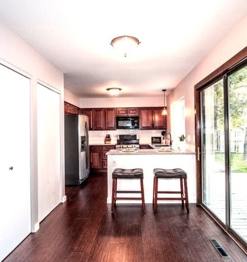 Transitional Kitchen - KitchenA Mid-sized Transitional U-shaped Kitchen With A Dark Wood Floor And A