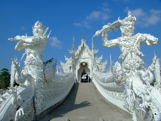 madeleineengland:  Wat Rong Khun, better known to foreigners as the White Temple, is a contemporary, unconventional, privately-owned art exhibit in the style of a Buddhist temple in Chiang Rai, Thailand. Chalermchai Kositpipat constructed it and