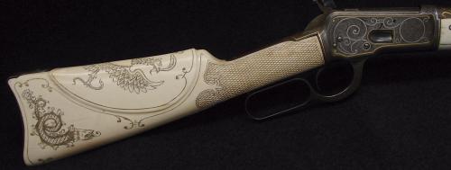 Winchester Model 92 lever action rifle with ornate scrimshaw ivory stock featuring Austrian Hapsburg