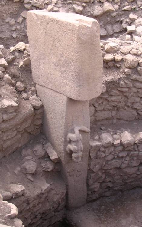 Pillar from Gobekli Tepe, in Turkey, with an animal scurrying down toward the ground. This archaeolo