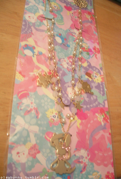 eeeee you guys my necklace is here!!!!     here it is! the fairy type focus necklace i didn’t even know existed up to a few days ago ;o; its prettier than i thought! it features little charms of swirlix and flabebe and of course a beautiful one