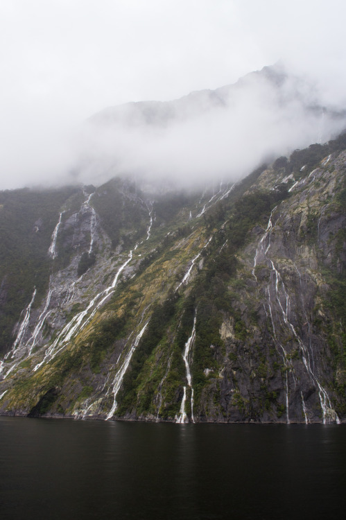 Waterfalls down steep valley walls in Milford Sound.Milford Sound, Fiordland, South Island, New Zeal
