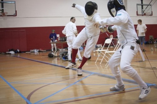 [ID: an epee fencer fleching/falling at his opponent.]Rene Hamilton (left) at the 2011 Iowa games!