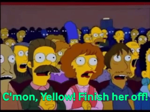 Homer Simpson, in a crowded auditorium and shocked audience, yelling 'C'mon Yellow! Finish her off!'