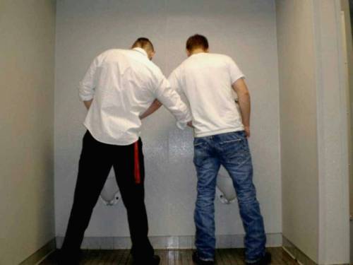 Helping each other out in the men’s bathrooms after sneaking a peak at the urinals. Stroke it!