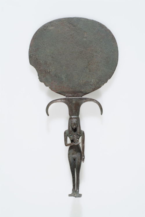 egypt-museum:Mirror: Isis with Horus as a babyThis bronze mirror portrays Isis as a figure of fertil