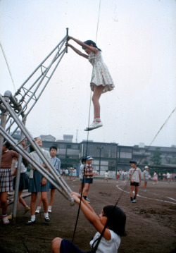 natgeofound:  A school girl soars twice her height in a standing version of a seesaw in Tokyo, Japan, November 1964.Photograph by Winfield Parks, National Geographic 