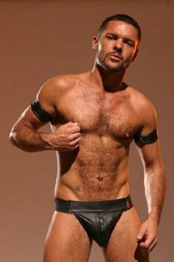 Leather guy tweaks his hardwired nipples.  For more gay nippleplay,