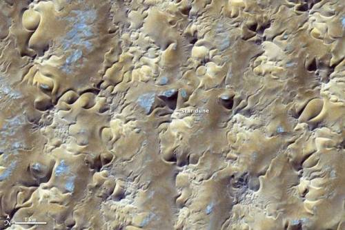 Star dunes from spaceDunes tend to accumulate in shapes dictated by the prevailing winds. Long lines