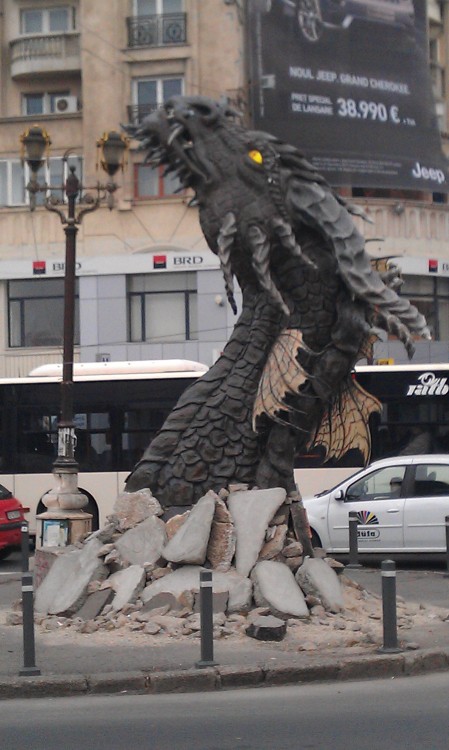 just-another-leaf-in-the-wind:beguilingblackness:Smaug The Sculpted, from Unirii (Union) Square in B