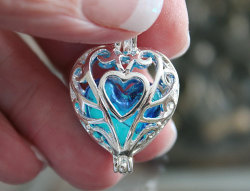 twerkingobserver:  anastasiawonders:  wickedclothes:  Glow In The Dark Heart Locket Necklace This heart-shaped silver locket holds a blue, glass, heart-shaped inside which glows bright blue in the dark. The locket features ornate carving to accent the