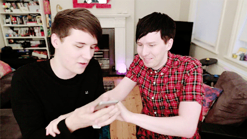 ughbeckyy: phil + trying to distract dan by shaking his arm