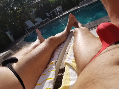 thong-jock:  Tanning poolside. Red muscleskins and black TM.  Hot mmm