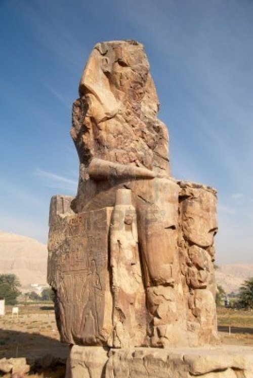 Colossus of Memnon - ancient Egyptian monument. Tho huge sculptures near the ruins of pharaoh’