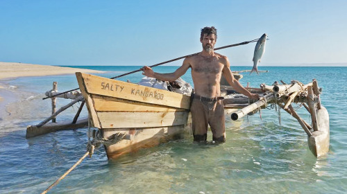 mrdingo:  This Guy is Sailing a Dugout Canoe