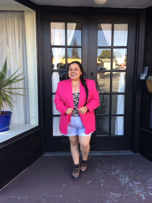 quelola:
“ [Image Description: A short fat Latina with a side braid wears a daisy print body suit, high waisted light wash blue shorts, a pink blazer and leopard print vans sk8 hi. Standing in front of a glass panel door way and smiling.]
”