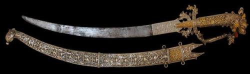 A nobles silver kasthane sword with solid gold mounts inlaid with pink sapphires. Sri Lanka, 18th ce