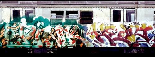Silver train with graffiti with words 