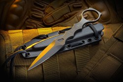 gunsknivesgear:  Spartan Close Quarter Battle Neck Knife. I wear neck knives under my button-up shirts.  With a little practice, it is easy to slip your hand in between the buttons to make a quick draw. I often enter tightly guarded buildings.  Guards