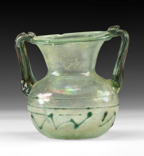 archaicwonder:Roman Two-Handled Glass Vessel with Trail, 4th-5th Century AD