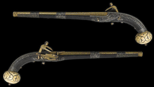 A gold and silver decorated miquelet pistol, leather wrapped and with an ivory butt, originates from