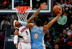 nba:  Andre Iguodala of the Denver Nuggets dunks and draws a foul from Josh Smith of the Atlanta Hawks at Philips Arena on December 5, 2012 in Atlanta, Georgia. (Photo by Kevin C. Cox/Getty Images)