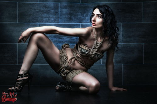 fineartofbondage:  Beauty tied in a rope harness, stunning posing lige a tied up lara croft :-) …for