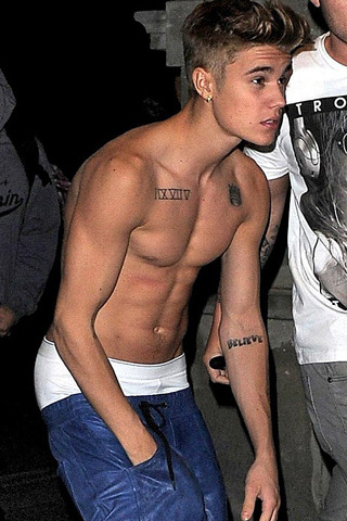 iballer:  Justin Bieber celebrating his 19th birthday shirtless in England. Justin is looking more buff every time we see him lately! 