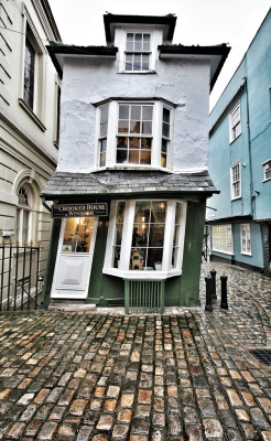 sixpenceee:  The Crooked House of Windsor in England is a building constructed in 1592. It is now a restaurant. The building now stands at a marked angle, having been rebuilt  in 1718. There is a secret passage in the basement, supposedly used for