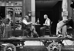 Un repas sur un camion, devant un commerce de café et de liqueurs, 25 rue d'Enghien, Paris, fin mai 1917.