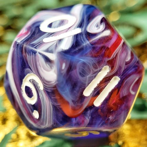 A beautiful oldie, Chessex Rainbow Lapis ❤️ [Image description: Macro shot of a d12. Deep, transluce