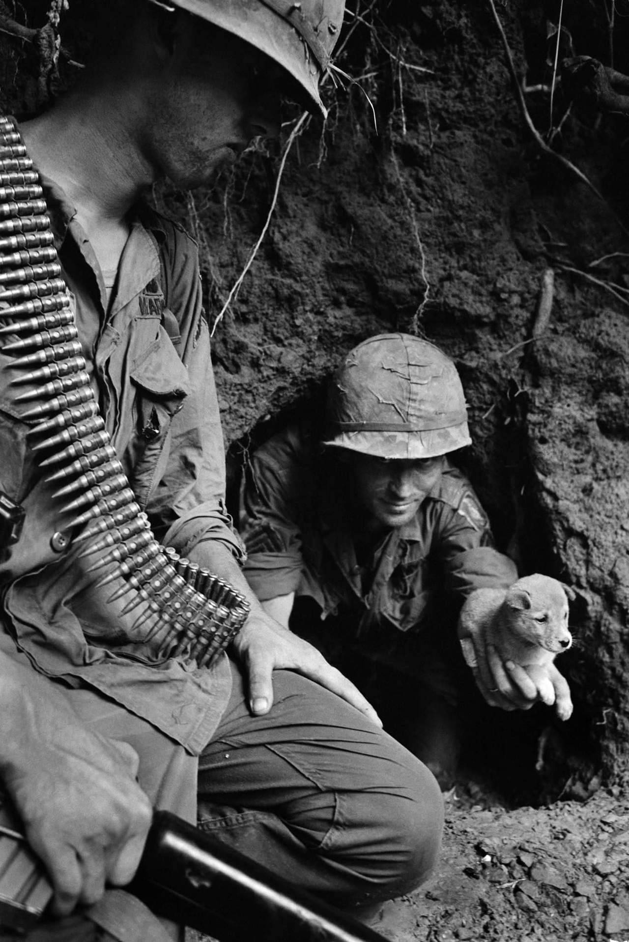greasegunburgers:  US paratrooper Sgt. James R. Cone, leaves a tunnel with a puppy