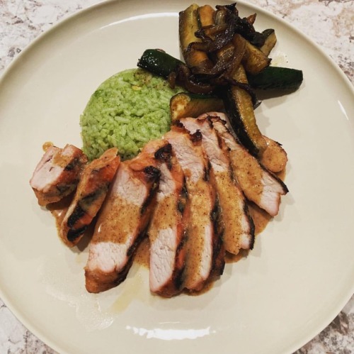 Ginger marinated grilled pork with a sesame almond sauce, cilantro rice, and sautéed zucchini and on
