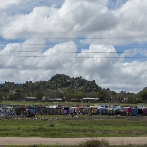 A Cyclist Rolls Past A Market In Mwanza, Tanzania. #mwanza #tanzania #africa #bicycle #cyclist #market