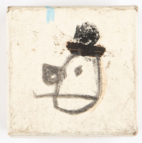 lightbeforelightbehindme:the hat1 1/4″ x 1 1/4″ x 9/16″charcoal, resin stick, graphite on cardboard 