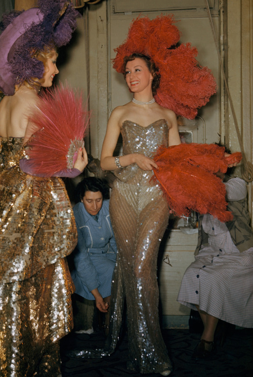 Seamstresses adjust performers&rsquo; costumes backstage at Folies Bergere in Paris, France, Jun