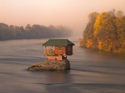 sixpenceee:  House Balancing on a Rock This house has been sitting on a rock in Serbia for over 45 years. It was first conceptualized in 1968 by a group of young swimmers and finally erected the following year as a one-room home. Though it may not be