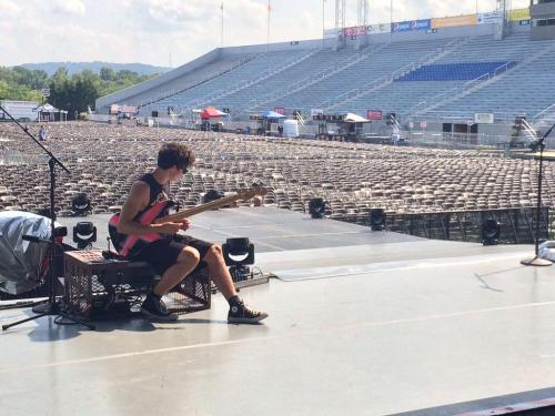 Some Pictures Of Calum Sitting Onstage For The Vibes