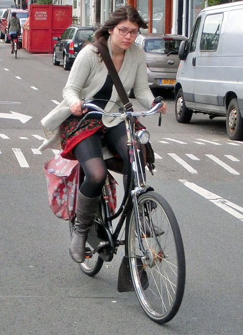 bicycle-amsterdam:  Nerdy girl on old style granny bike with drum brakes. Downtown, Amsterdam.