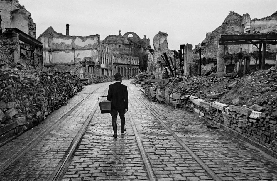 collectivehistory:  A man walks through a destroyed city in Germany looking for food,