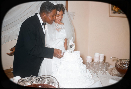  1950s newlyweds with their wedding cake. adult photos