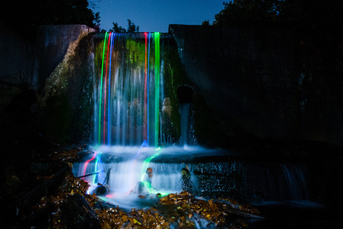 fromthelenzmedia:Neon Falls.Light trails of glowsticks shown through the movement of the water.