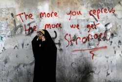 unrar:  A Bahraini anti-government protester watches riot police, unseen, during clashes in Diraz, Bahrain on May 6, 2013. Large numbers of riot police stormed the area just ahead of a planned demonstration in support of jailed activists, chasing away