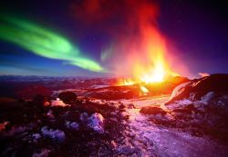 throne-of-perdition:  Northern Lights over an Erupting Volcano In April 2010, the Icelandic volcano Eyjafjallajökull spewed great ash clouds into the sky and caused enormous disruptions to air travel in Europe. The eruptions are best remembered for this