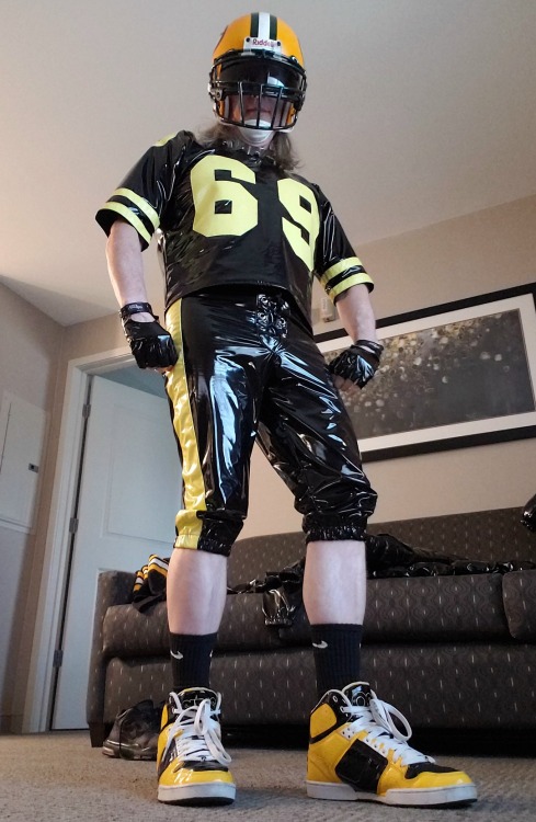 Ready to stir things up somewhere in PVC football gear, helmet, spiked collar, and shiny Osiris rear