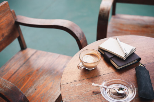 Coffee cup on rustic wood table by silaaa