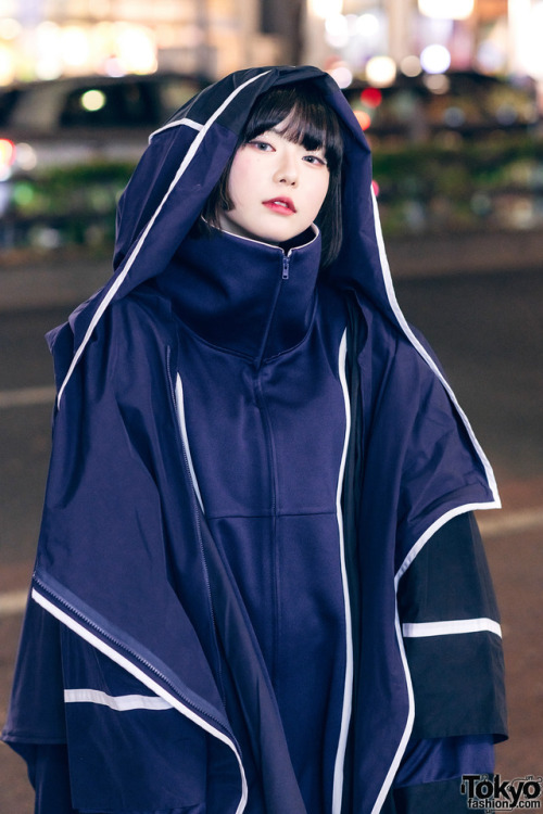 16-year-old Japanese student Kana on the street in Harajuku wearing a hooded coat by the futuristic 