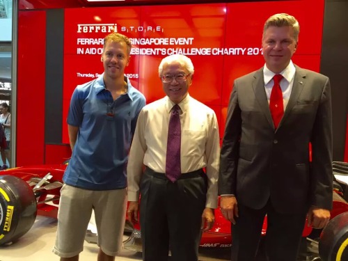 ivettelftmesut:

Sebastian Vettel with Singapore President dr Tony Tan at Ferrari store charity event #stopppppp he was wearing those horrible/great loose shorts with that shirt? ugh. of course he did #sebastian vettel #singapore gp 2015 #blue polo