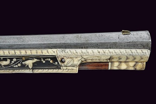 A beautiful 17th century wheel-lock rifle decorated with bone, silver, and gold.  Most likely G